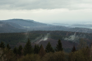 Fototapeta na wymiar View from Velmerstot overlooking the teutoburg forest (germany) on a stormy, rainy day in spring.