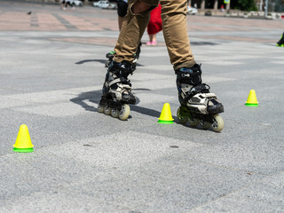 Close-up view of male legs in roller skates. Figure skating on roller skates.