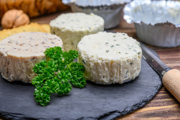 Spread cream cheese with herbs, garlic, chives and spices close up