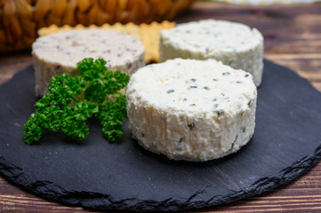Spread cream cheese with herbs, garlic, chives and spices close up