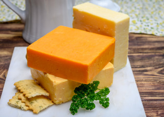 Leicestershire cheese or red leicester and mature cheddar, variety of British hard cheeses made from cow milk