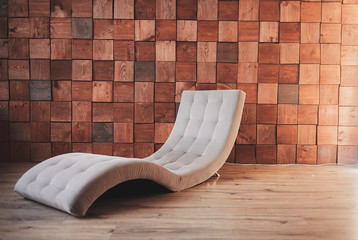 stylish modern chair in the interior and wooden wall