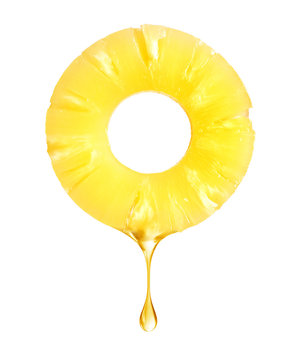 A Drop Of Juice Falls From A Pineapple Ring On A White Background