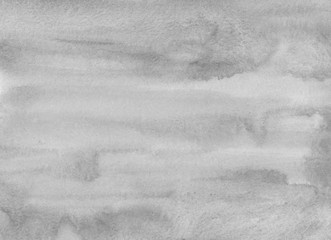 Watercolor light gray background texture. Grey abstract backdrop. Monochrome stains on paper.