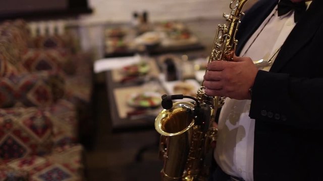 Men playing saxophone. Close up of men playing saxophone