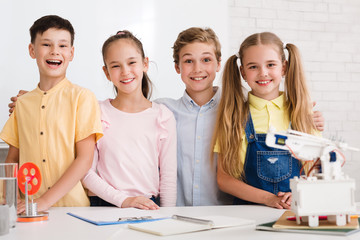 Happy children after stem class smiling to camera together