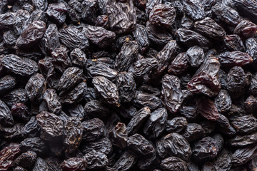 Black raisins background. Vegetarian healthy snack. Organic food. Vegetable diet.