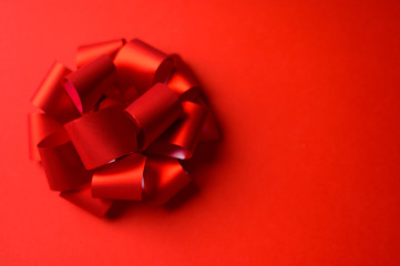 Festive beautiful red bow on a red background.