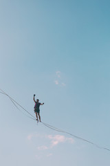Highliner on the background of blue sky.
