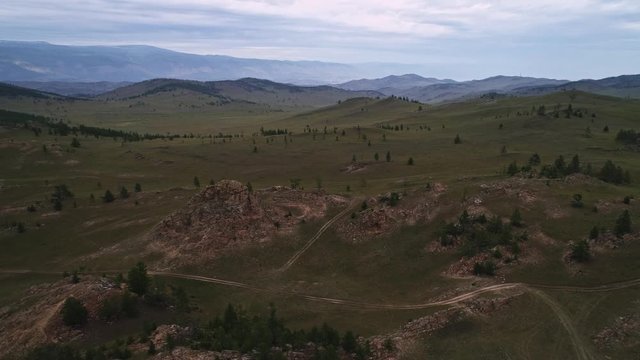 Baikal Valley spirits,Tazheran steppe, stone cliffs on the road. Aerial Summer