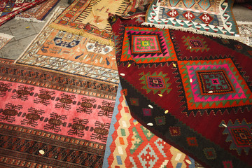 Georgian Culture, Travel concept. Traditional ethnic carpets laying on the street market in Tbilisi, capital of Georgia. Outdoor shot
