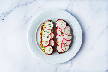 Radish avocado and ricotta avocado  rye sandwiches