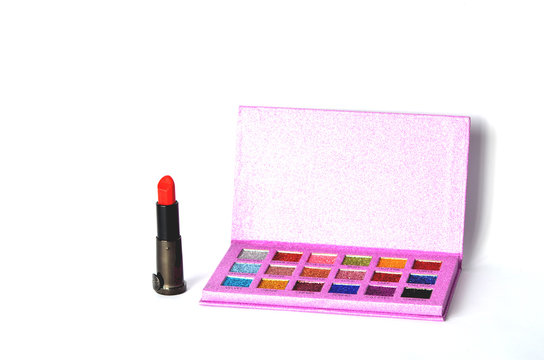 Photo of lipstick and shadow palette on light background, fashion photo for professional make up