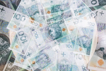 Blurred Polish banknotes. One hundred Zloty pile background.