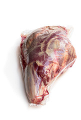 Vacuum pack of raw lamb leg isolated on white