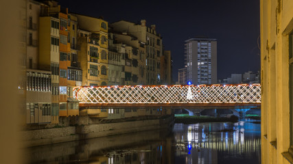 Fototapeta na wymiar iluminated bridge of a town at the night