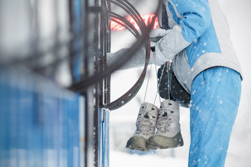 People is buying a ski pass to the lift in the cashbox of ski resort.
