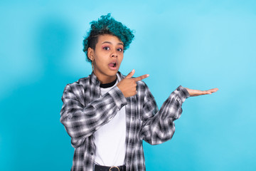 afro american girl isolated on color background pointing
