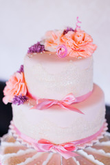 Obraz na płótnie Canvas chic wedding cake on a three-tier stand. cake decorated with rib