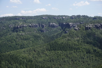 Impressive sandstone rocks peeling out of the forest in the Schrammsteine region
