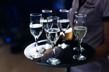 closeup of a waiter with a tray and glasses of champagne. weddin