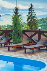 Wooden deck chairs for relaxing by the pool