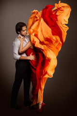 Couple in Love, Man Kissing Hidden Woman Lips in Fluttering Cloth as Flame Flower