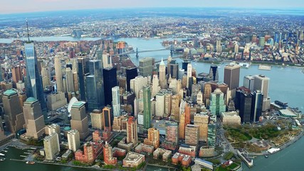 Aerial view of skyscrapers in Lower and Midtown Manhattan. Brooklyn and Manhattan Bridge in the background. Shot from a helicopter.  