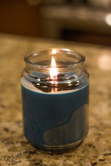 Generic blue wax candle on countertop
