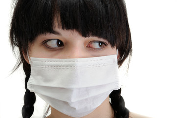 close-up portrait of young woman in protective medical mask on white background 