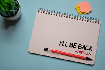 I'll Be Back - Jesus write on a book isolated on office desk. Christian faith concept