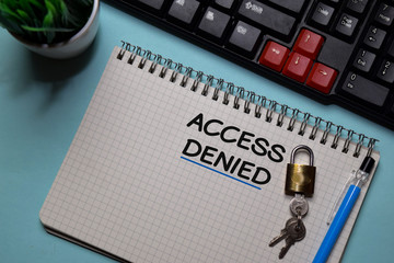 Access Denied write on a book isolated on office desk.
