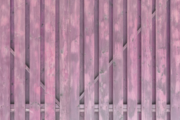 A fragment of a painted wooden gate. The structure of the boards and battens. Light purple surround background for layouts.
