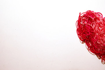 Red heart made of threads on a white background Valentine's Day banner place under text