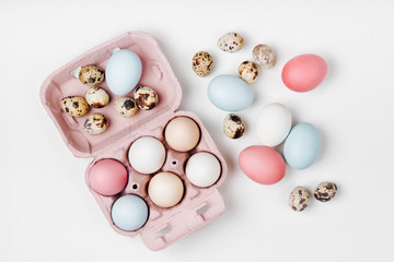 Natural Colored brown and white Eggs in egg box. Compositions in pastel colors. Easter consept.  Flat lay, top view