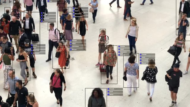 Crowded building with commuters walking. Artificial intelligence and facial recognition are used for surveillance purposes. Individual data showing sex, race and clothing. Deep learning. Futuristic.
