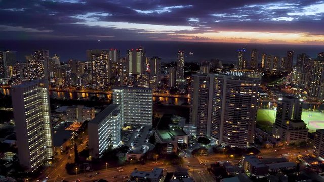  Honolulu skyline. Aerial view of Waikiki skyline, Ala Wai canal and Kapi olani Regional Park. Oahu is the third largest Hawaiian island. Hawaii, United States. Dusk.