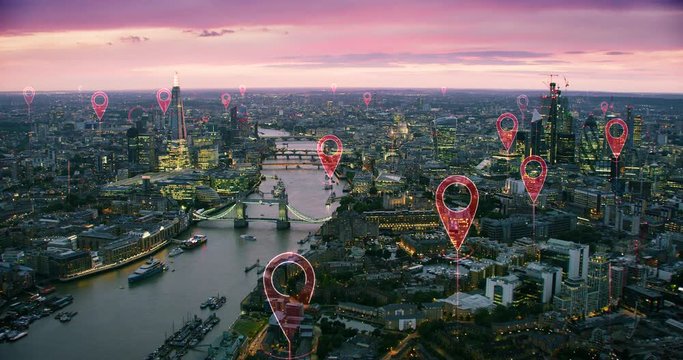 Aerial smart city. Localization icons in a connected futuristic city. Technology concept, data communication, artificial intelligence, internet of things. London skyline. Shot on Red Weapon 8K.