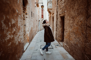 .Pretty young girl traveling around the island of Malta. Knowing its culture and visiting the old...