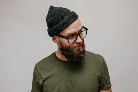 Handsome hipster guy with beard wearing blank casual beanie. Mockup for print