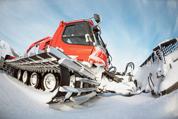 Snow compaction machine on the winter snow background.