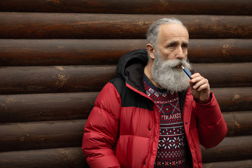 Old bearded man face, winter portrait outdoors.