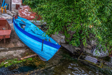 Close up of one old wooden blue boat on the dock. Ohrid Lake, Spring,  North Macedonia.