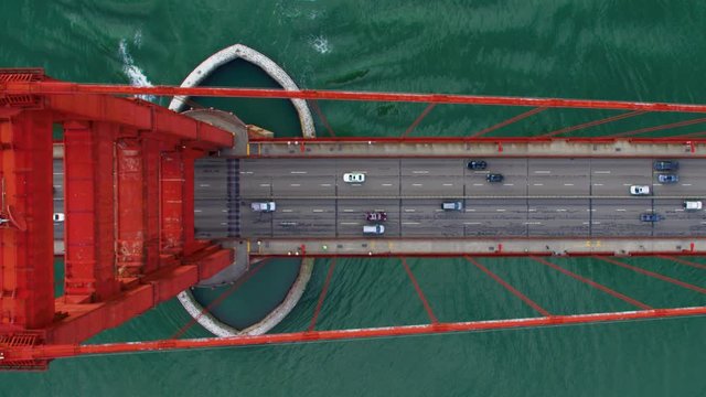 Traffic passing by the Golden Gate Bridge. San Francisco, US. Aerial view. It connects the San Francisco peninsula to Marin County. US route 101 and SR 1 full of cars. Shot on Red weapon 8K.