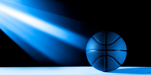 Basketball ball isolated on black background. Blue neon Banner Art concept