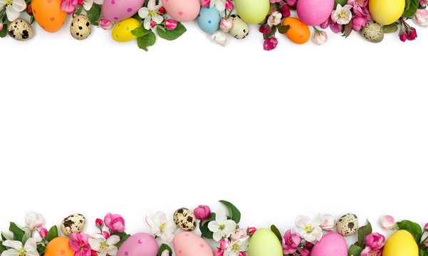 Easter decoration. Pink flowers apple tree and colored easter eggs and quail eggs on white background with space for text. Top view, flat lay