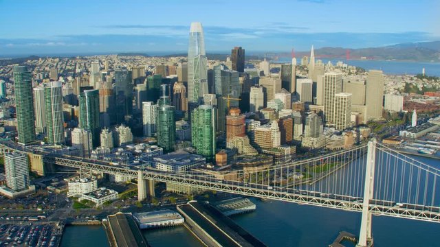 Aerial view of the San Francisco Oakland Bay Bridge. California, USA. With traffic. Financial District skyline with its well known skyscrapers. Shot on Red weapon 8K.