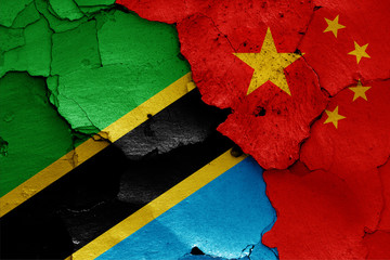 flags of Tanzania and China painted on cracked wall