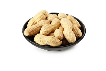 Dried peanuts in a black plate isolated on white background. Food