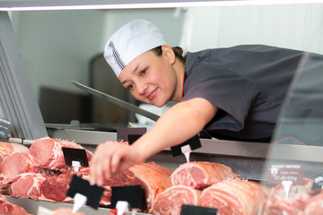 portrait of woman cutting meat